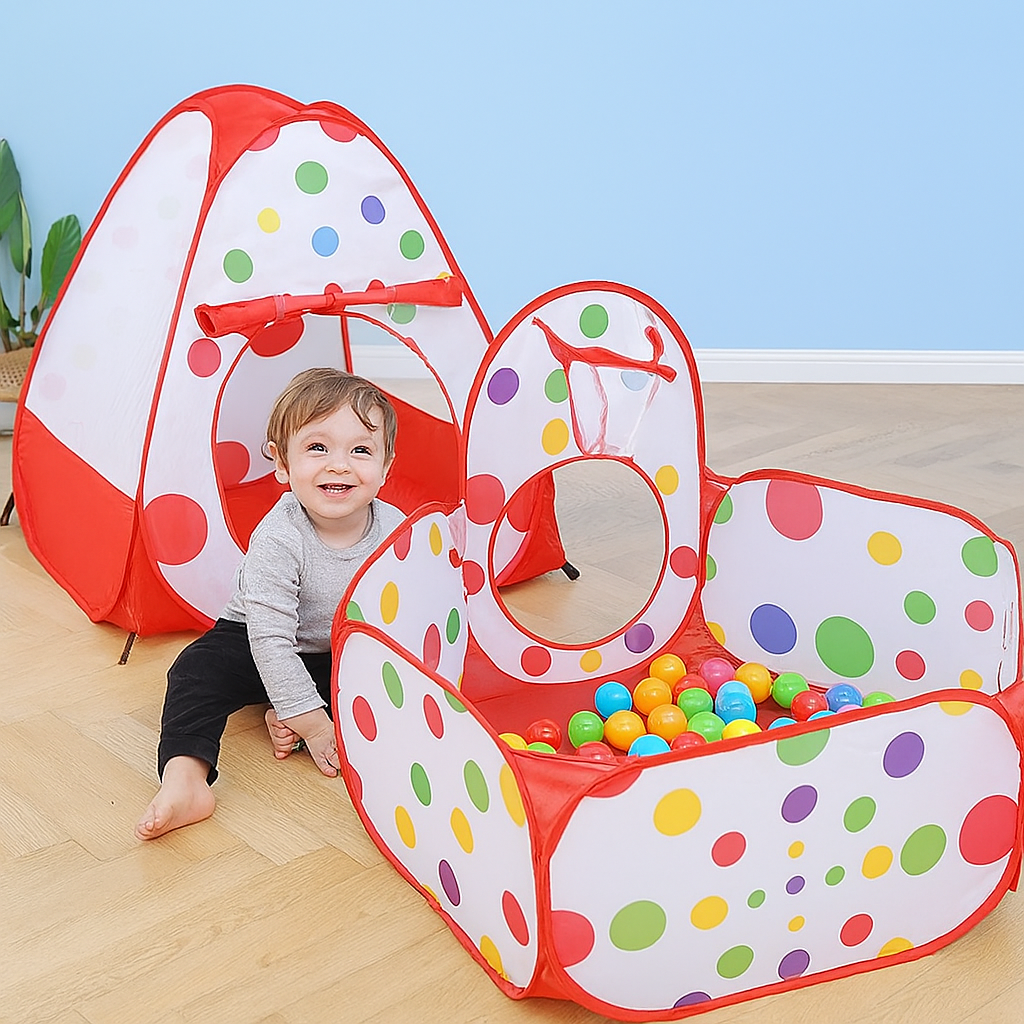 Child playing with a colorful polka dot play tent on a wooden floor.